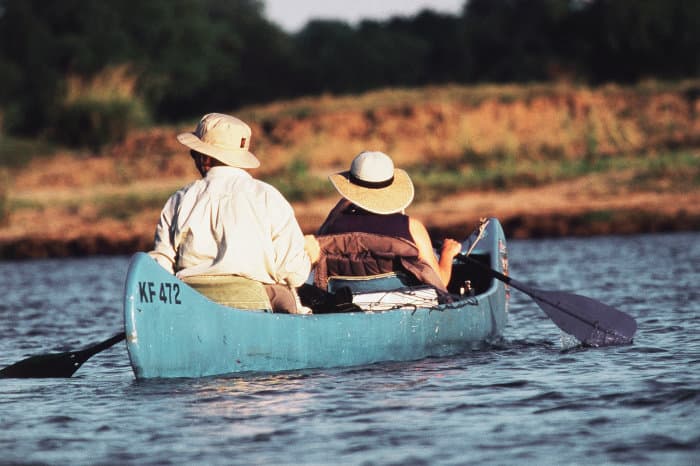 Couple canoeing on the Zambezi river in Mana Pools