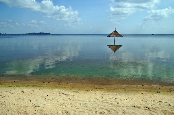 Beach umbrella in water, seen from Bugala island