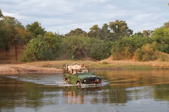 Jeep crosses the river on an African safari in the Lower Zambezi