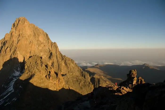 Climber stops to admire the view, as it reaches the top of Mount Kenya