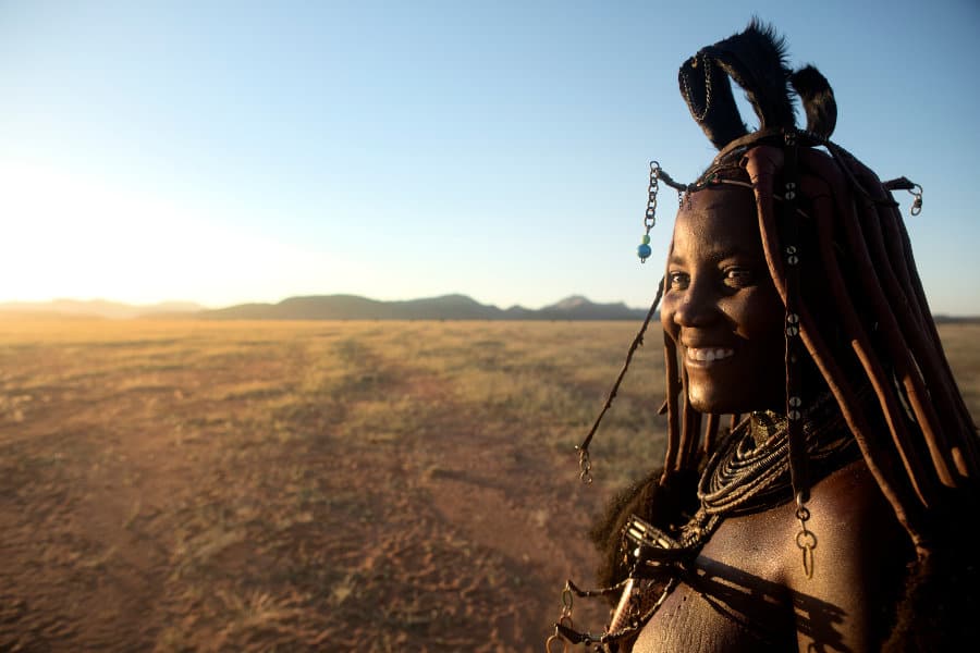 Elegant Himba woman with a huge grin on her face