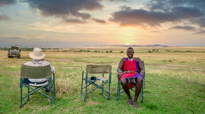 Tourist and safari guide enjoying a break in the Masai Mara reserve, Kenya