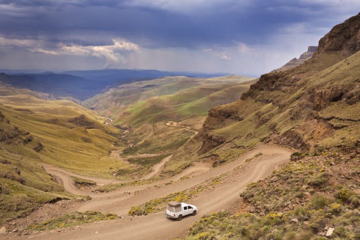 Car driving the sharp turns of the Sani Pass, on the border of South Africa and Lesotho