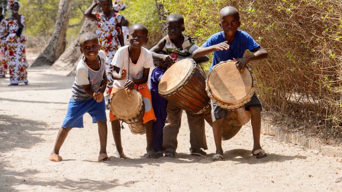 Four kids playing the djembe in Casamance, Senegal